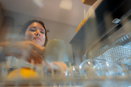 Woman loading dishes into a dishwasher
