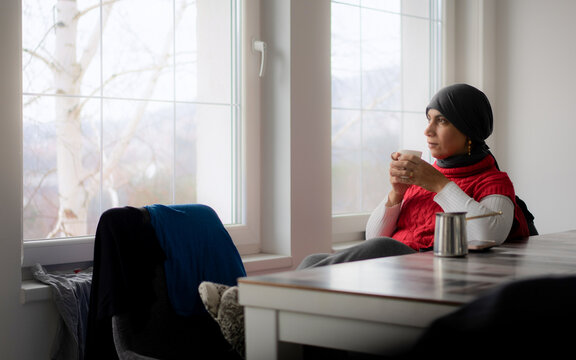 Drinking Coffee by Window