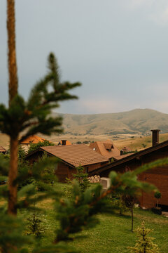 Wooden cabins with hills in summer landscape