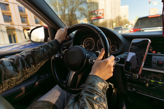 Person Driving Car  with Smartphone Mounted on Dashboard 
