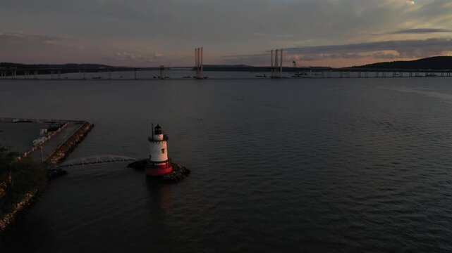 Aerial view of Sleepy Hollow Lighthouse on the Hudson River with the Tappan Zee Bridge in the background at sunset Sleepy Hollow, New York, United States.