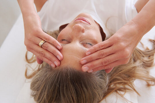 Close-up of woman touching her forehead