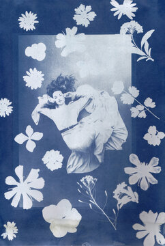 Woman floating in cyanotype with flowers
