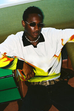 Portrait of man in sunglasses on green sofa film photo
