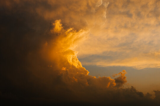 Dramatic storm clouds glowing at sunset