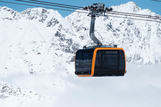 Massive cable car cabin in Tyrol with snowy mountains and fog 