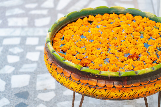 Marigold flowers floating in decorative bowl