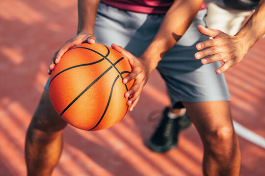 Intense game of basketball on a sunny outdoor court