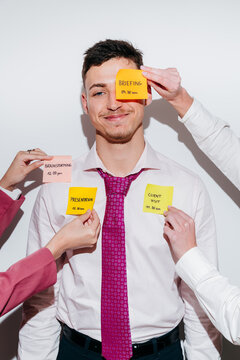 Happy man smiling with sticky notes for different work tasks