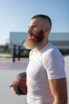 Male bearded basketball player during training