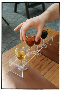 Hand selecting glass from port wine tasting set in Porto Portugal