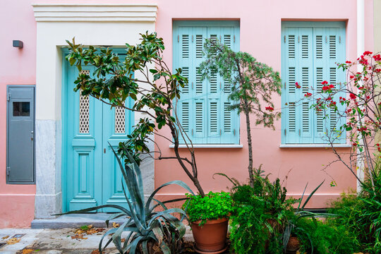 Turquoise shutters with blooming red flowers