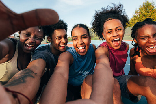 Group taking a joyful selfie outdoors