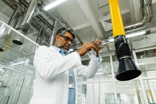  Indian scientist in white coat working in laboratory