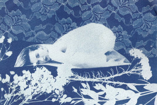 Woman sleeping among delicate flowers 