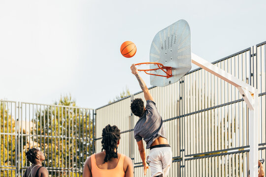 Outdoor basketball game with players in action