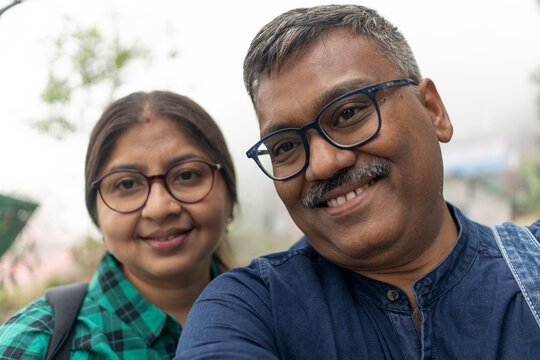 Middle aged couple taking selfie at outdoors