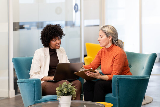 Diverse businesswomen collaborating during a meeting indoors