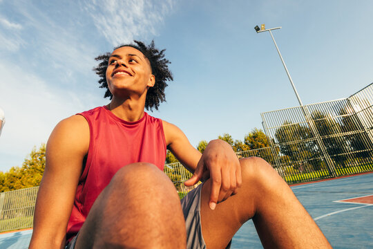 Young athlete smiling on outdoor basketball court