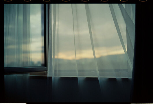 Sheer curtain by open window