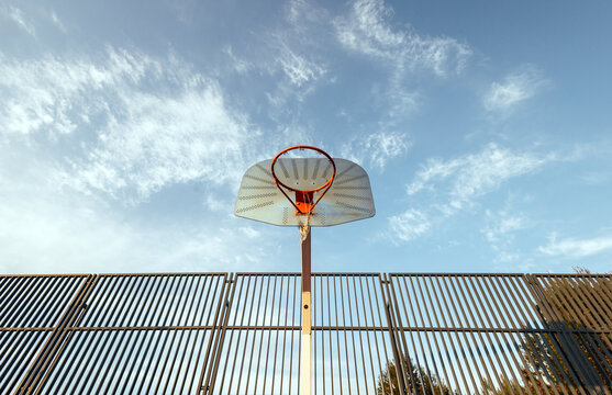 Basketball hoop against a blue sky backdrop