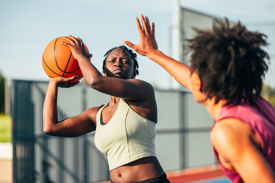 Outdoor basketball game highlighting intense competition
