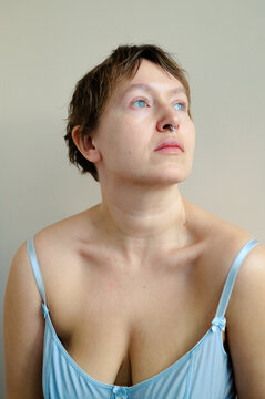 A close-up portrait of a woman looking away.