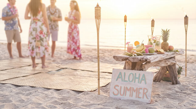 Aloha summer beach luau party setup with tiki torches and fruit