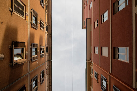 Narrow Urban Alley Between Tall Residential Buildings