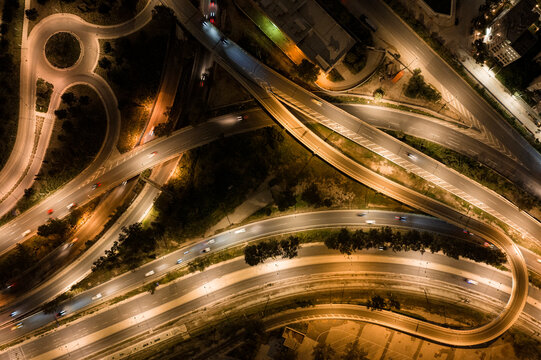 Aerial view complex highway interchange at night, busy traffic