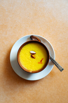 Saffron-flavored Indian dessert served in clay bowl