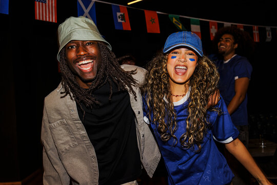 Diverse supporters cheering for sports team