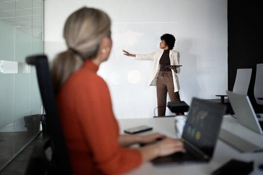 Black businesswoman presenting global strategy in meeting