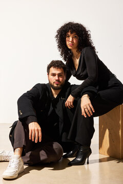 Couple posing together in studio setting during daytime