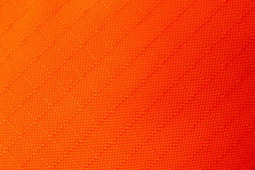Obraz premium Vibrant orange fabric texture background showing detailed woven pattern with energetic warm feeling perfect for modern textile design and bright material backdrop