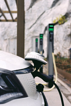 Close-up of electric car recharging on charging station.