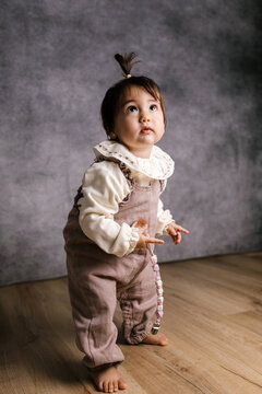 Curious baby girl looking up with innocence