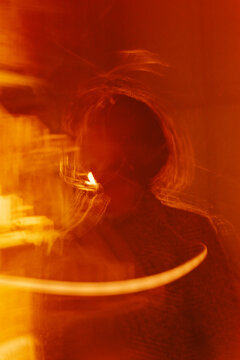 Abstract motion blur portrait with warm film light leaks