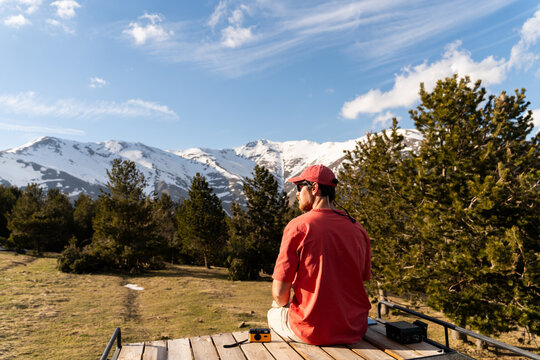 Man on roof deck camper van relax travel mountain