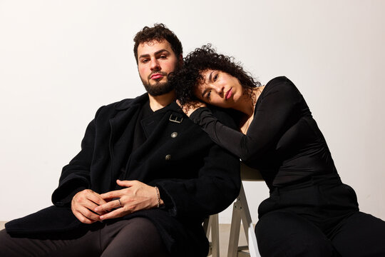 Couple sitting together in casual setting, sharing a moment