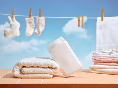 Clean laundry drying on a line with a detergent bottle and towel