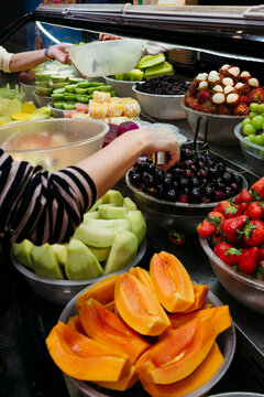 Colorful Fruit Display at a Bustling Market on a Sunny Day