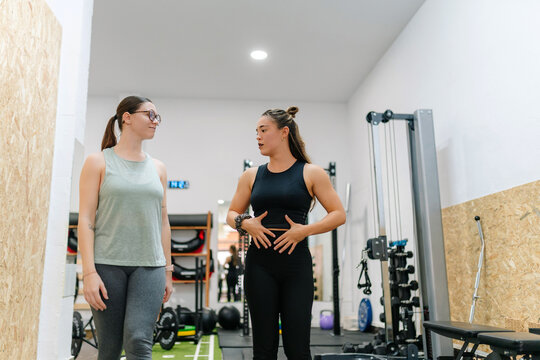 Personal trainer teaching functional breathing with client