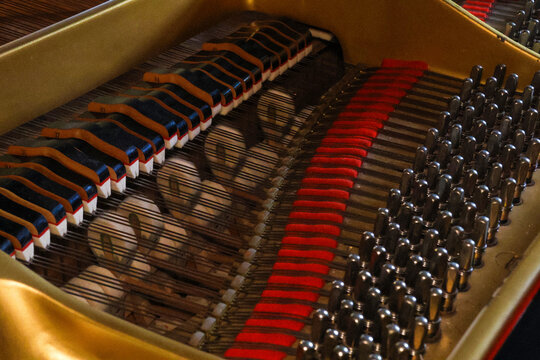 Side view over the strings of an opened classical grand piano