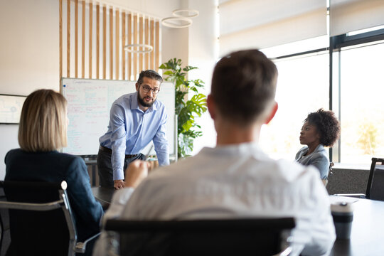 Male boss briefing multiethnic employees