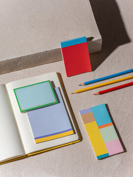 Colorful stationery items arranged on a textured surface