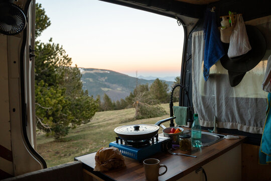 Cooking in a Camper at Sunset in the Mountains