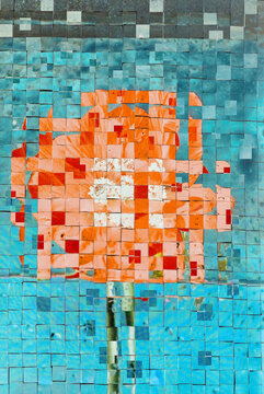 Bright orange flower design made with small tiles