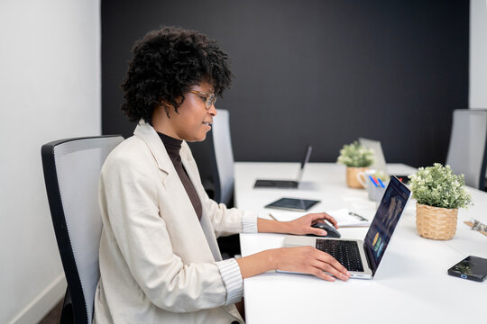 African american businesswoman working on laptop in modern office