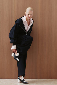 Studio fashion portrait model adjust shoe